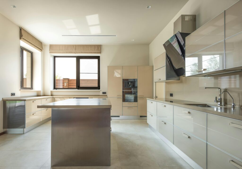 Bright and spacious modern kitchen interior featuring sleek cabinets and a central kitchen island.