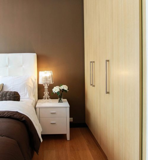 Elegant bedroom with modern furniture, soft lighting, and cozy ambiance.